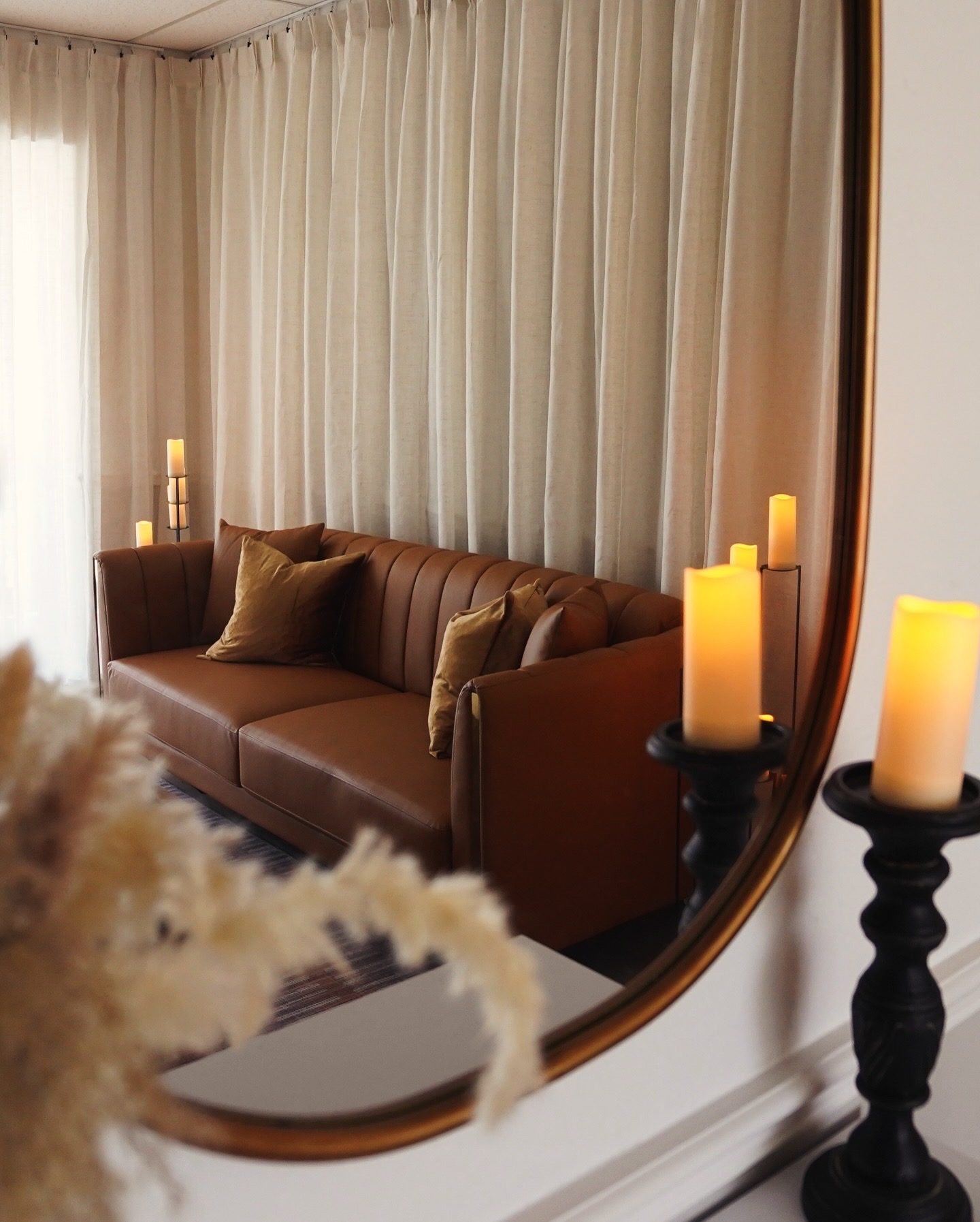 Studio lounge with leather sofa and candles